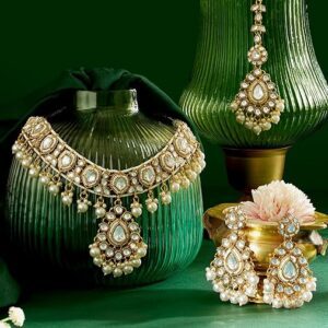 Poojavi Gold Tone Dazzling Stones & Pearls Drop Choker Necklace Earring & Maangtikka Set For Women